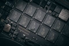 A modern data center and computer chip representing AI infrastructure.